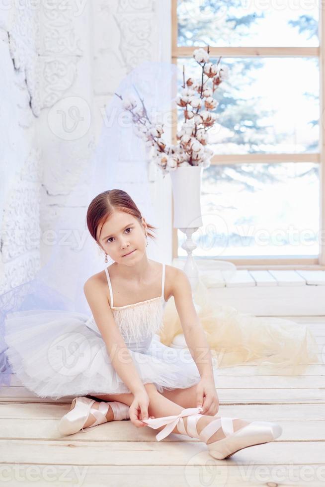 Little prima ballet. Young ballerina girl is preparing for a ballet performance photo