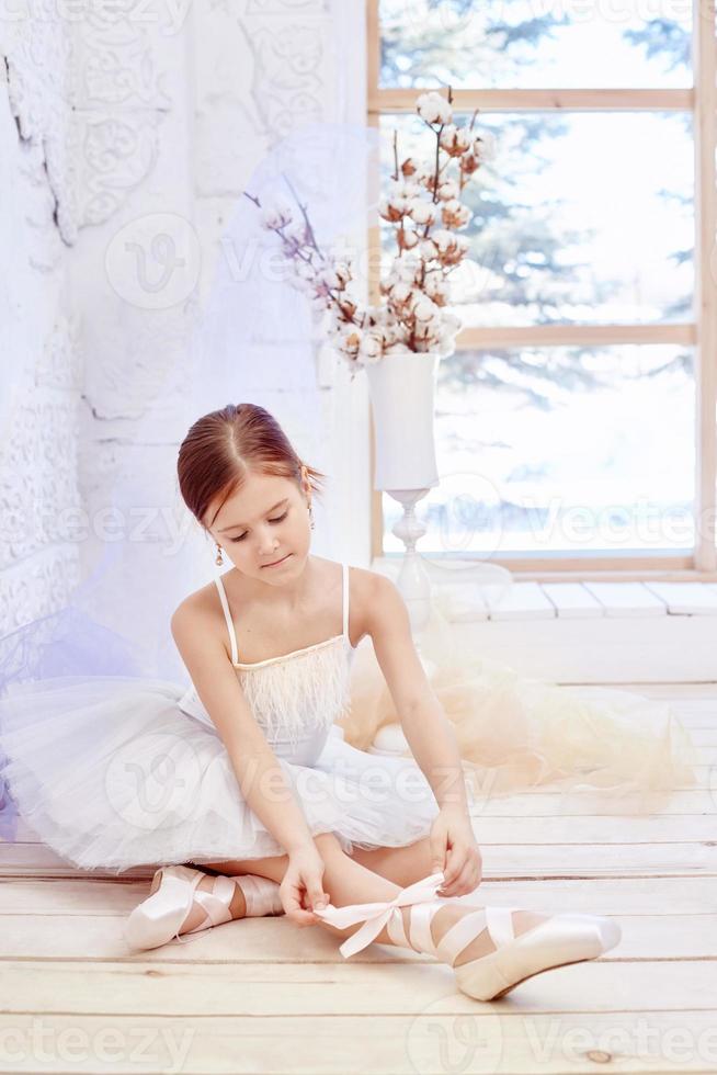 Little prima ballet. Young ballerina girl is preparing for a ballet performance photo