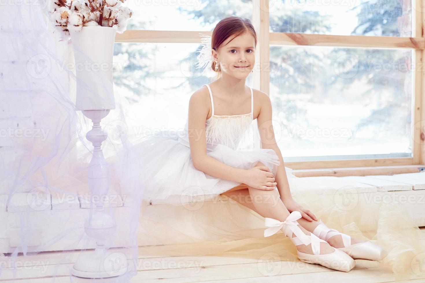 Young ballerina girl is preparing for a ballet performance. Little prima ballet photo