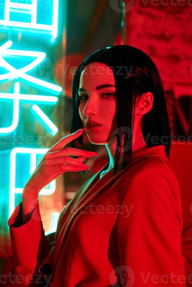 Anime woman in a red suit with short hair cut, black hair. The killer girl in the red jacket. Beauty portrait photo