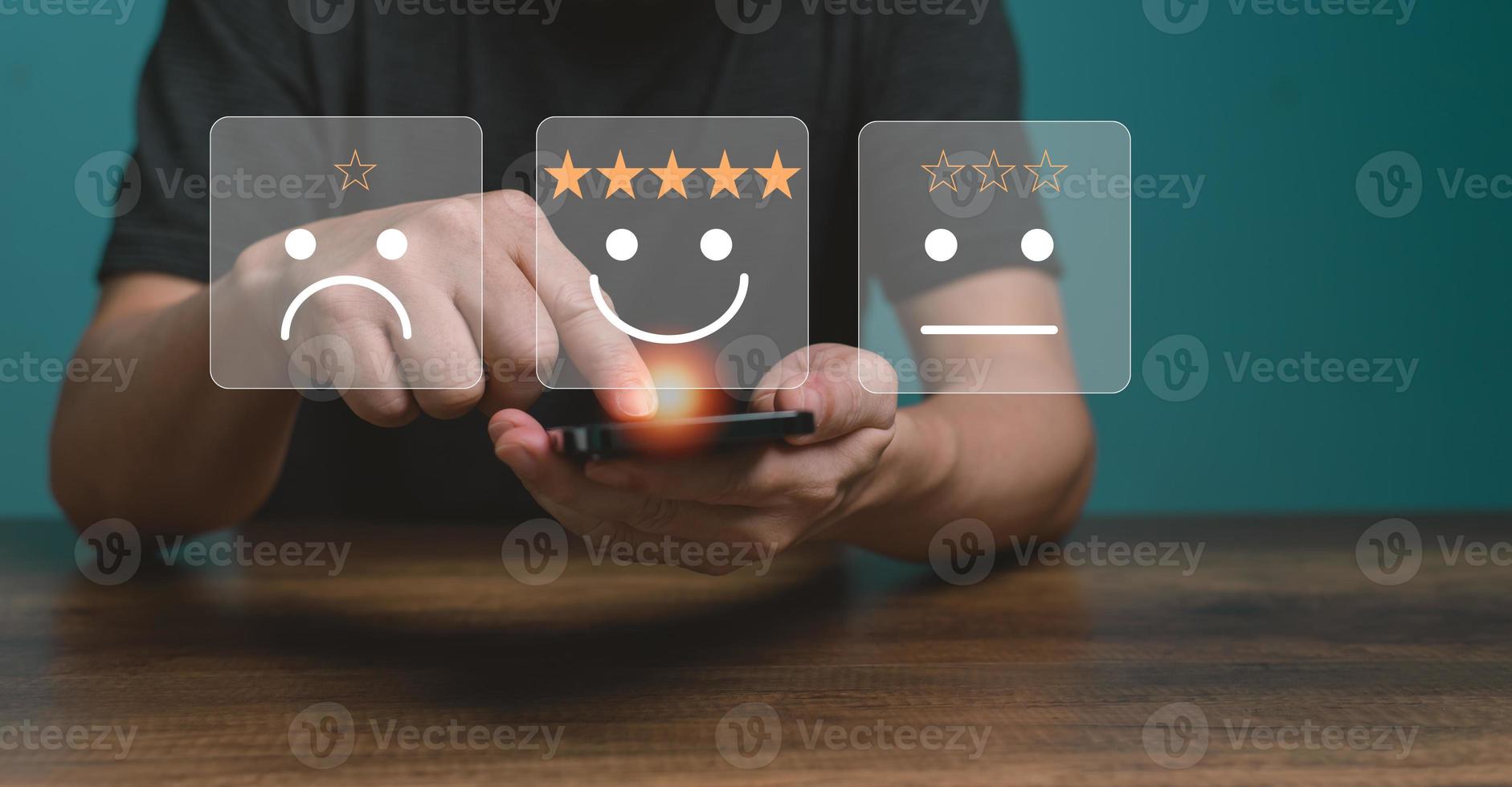 Customer service and Satisfaction concept ,Business people are touching the virtual screen on the happy Smiling face icon to give satisfaction in service. rating very impressed. photo