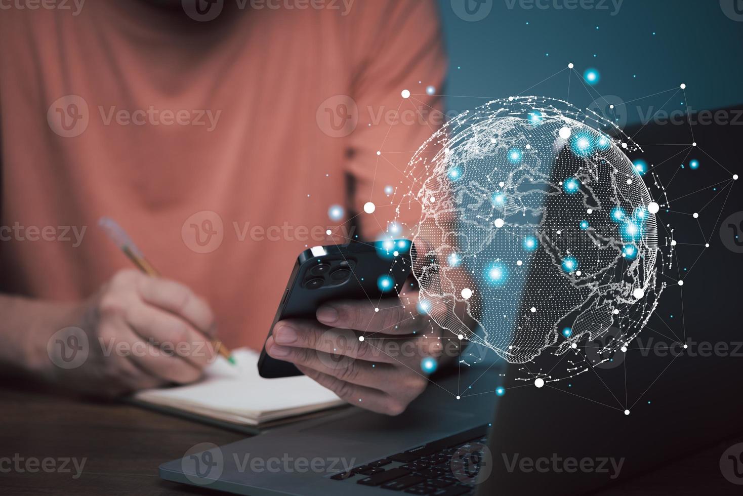E learning concept. Casual business man studying online course via laptop computer and writing on notebook. photo