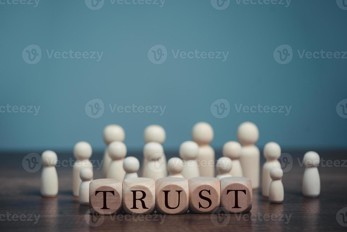 Wooden blocks with the word Trust, Trust relationships between, reliable partner, business partners, confidence person, friends, relatives, respect and authority. photo