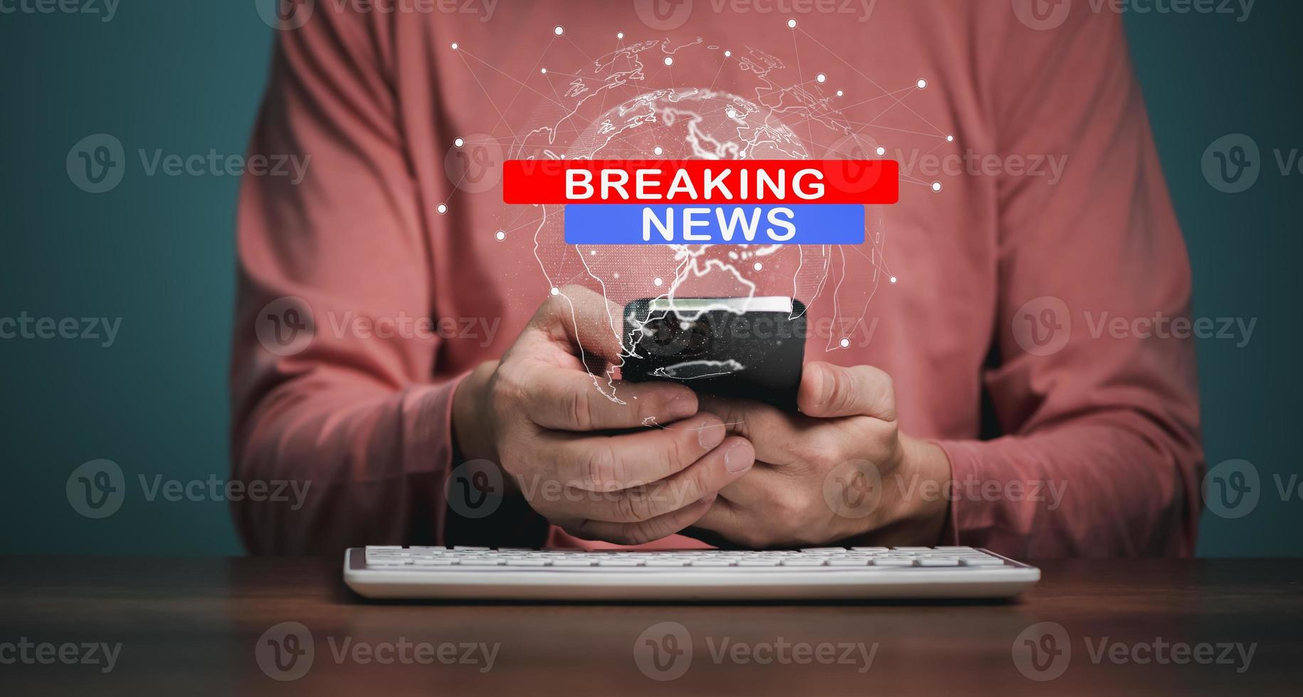 Breaking News, broadcast channels or internet tv concept, Man holding Mobile phone with World Global news background design. photo