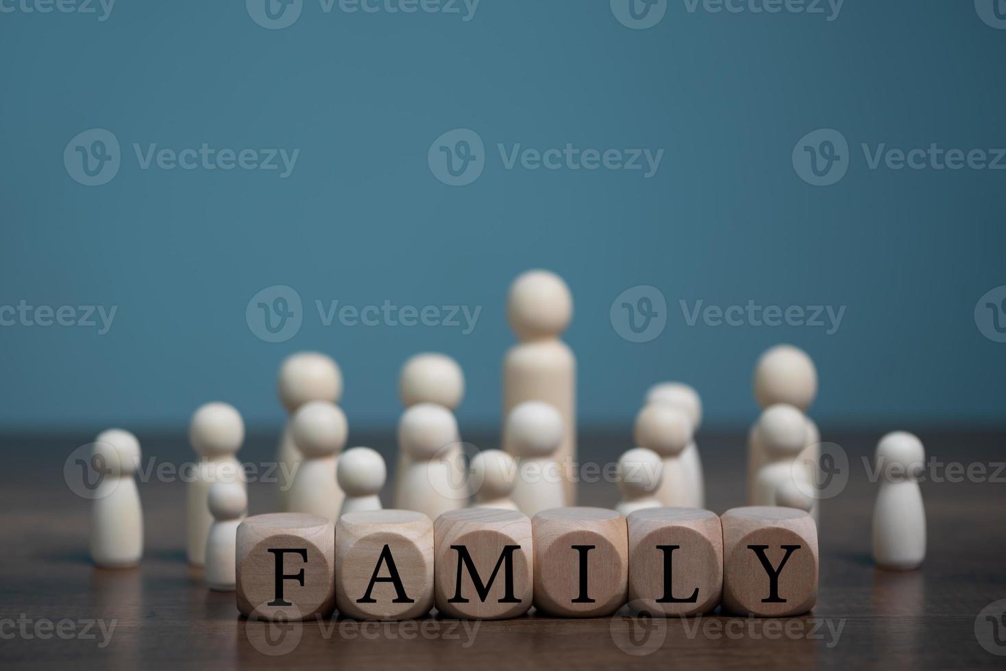 Happy Family concept, Group of wooden doll living together with love and wooden block with word family letters. photo