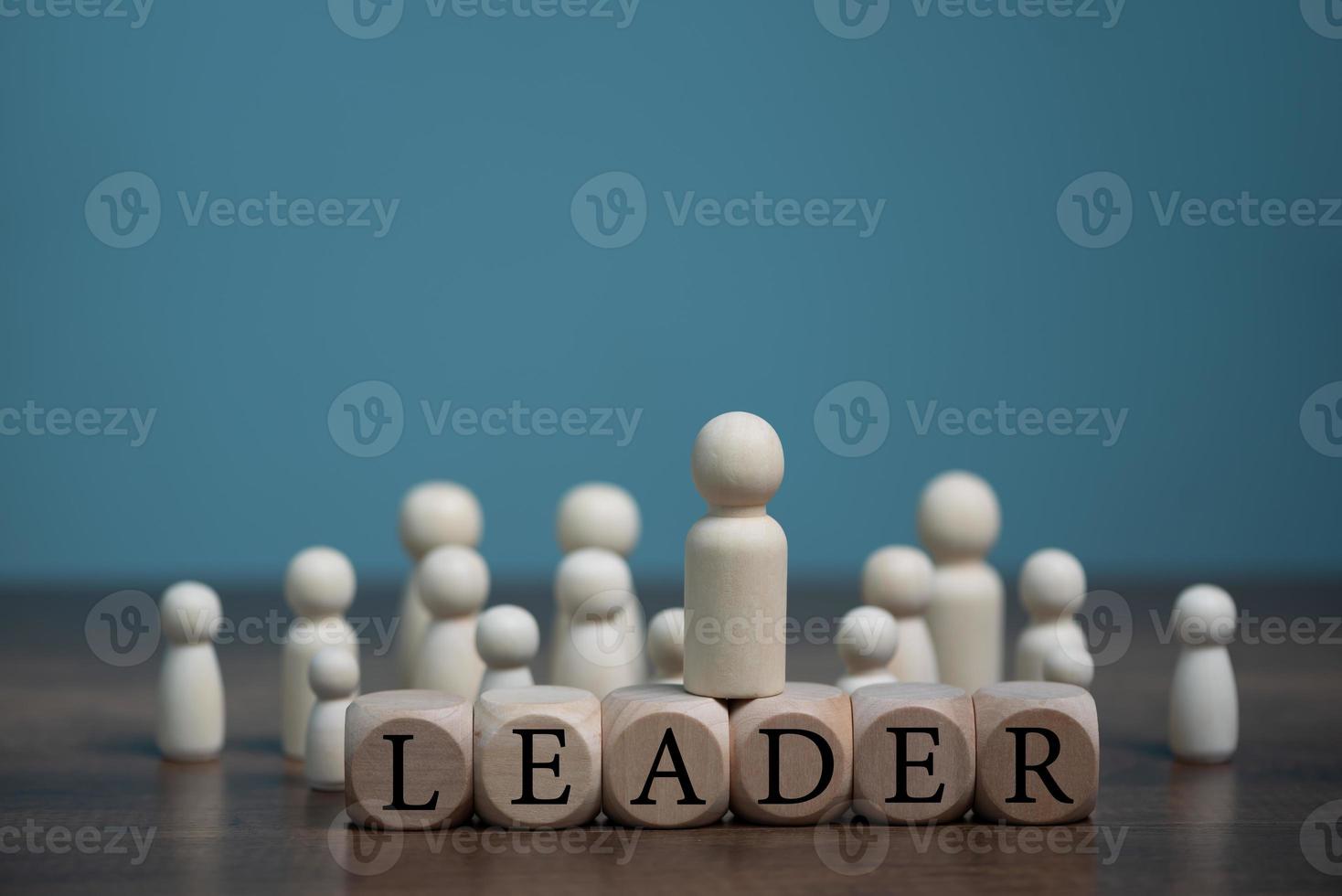 Leader of the business team concept, indicates the direction of the movement towards the goal. Crowd of people goes for the leader, isolated on light blue with copy space. photo