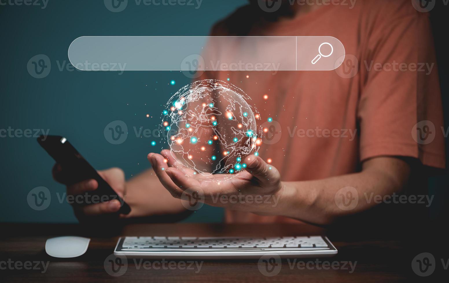 Searching online internet concept. Hand hold the earth with earth map and Mobile phone, online internet searching bar address in virtual screen. Online technology connect people in the world together photo
