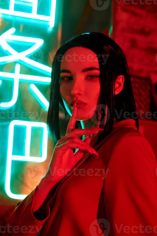 Anime woman in a red suit with short hair cut, black hair. The killer girl in the red jacket. Beauty portrait photo