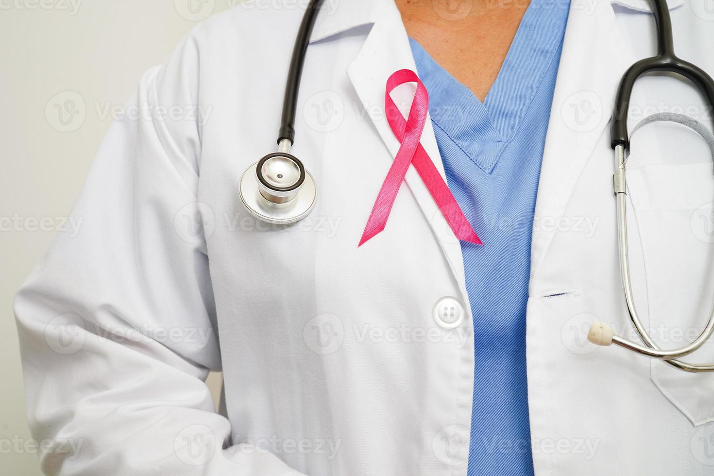 Asian woman doctor with pink ribbon, World Breast Cancer Day at October. photo