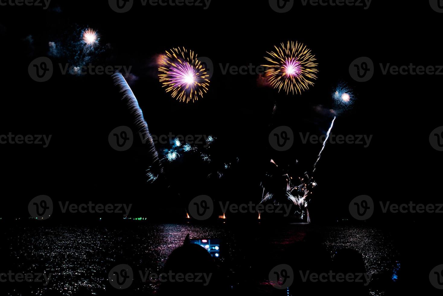 fireworks celebration over sea on pattaya beach photo