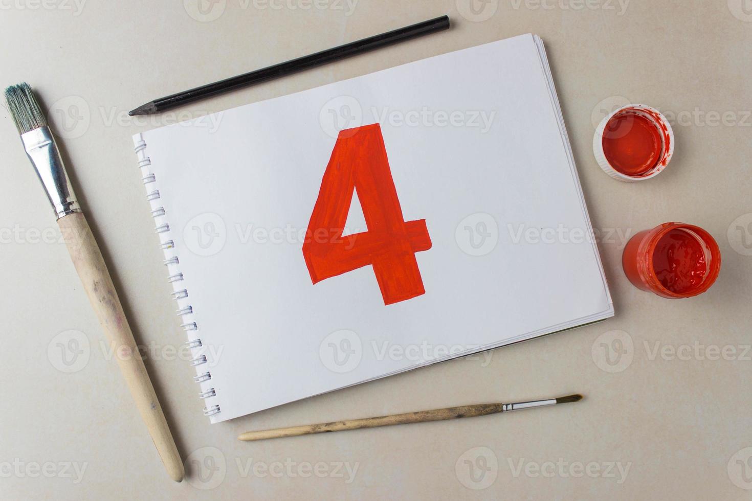 Red number four drawing on a white album sheet. To indicate the place, price, etc. photo