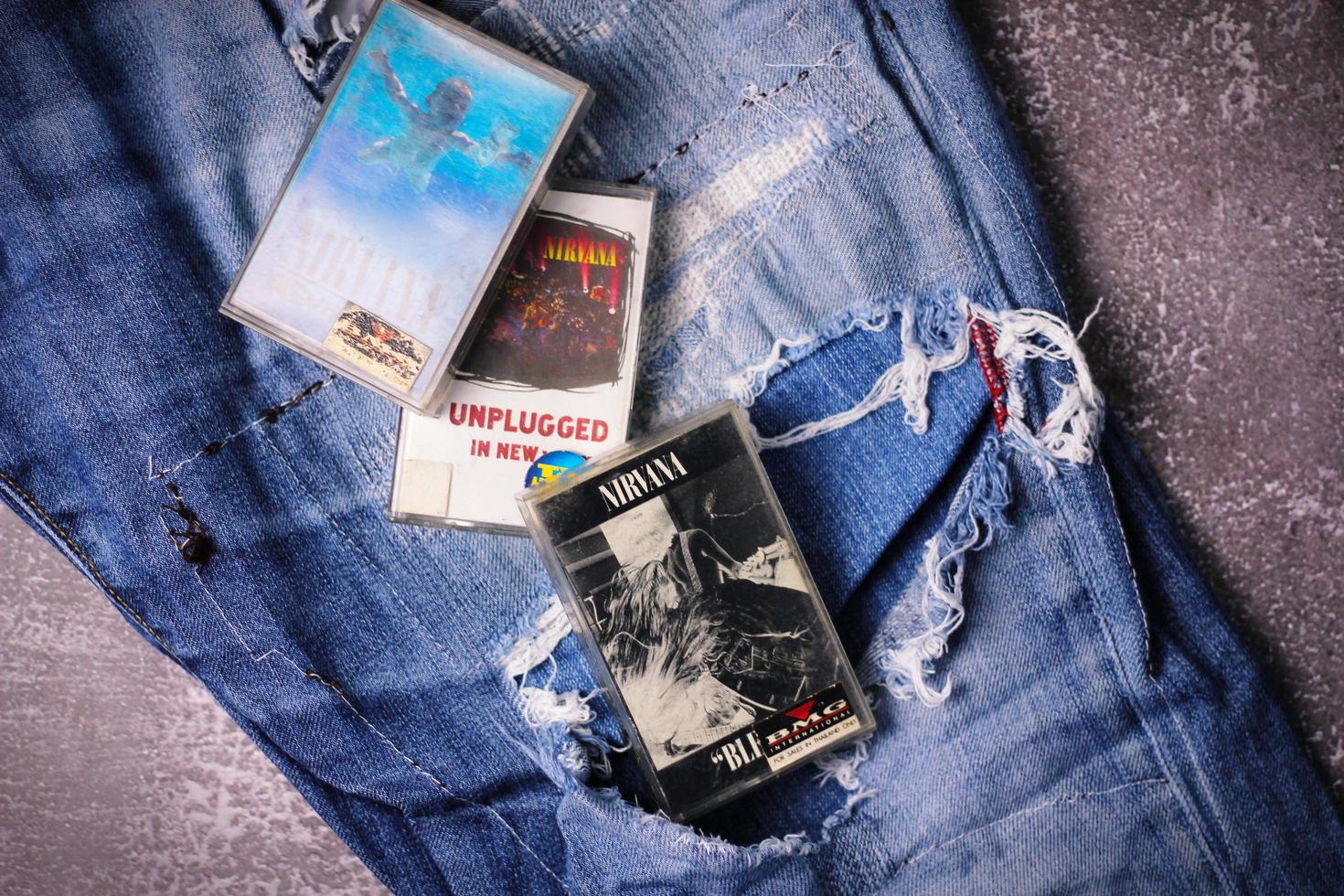 WASHINGTON USA - September 30 2022  Nirvana's cassette tape and Ripped jeans or Torn jeans. A symbol of the grunge or Seattle sound. photo