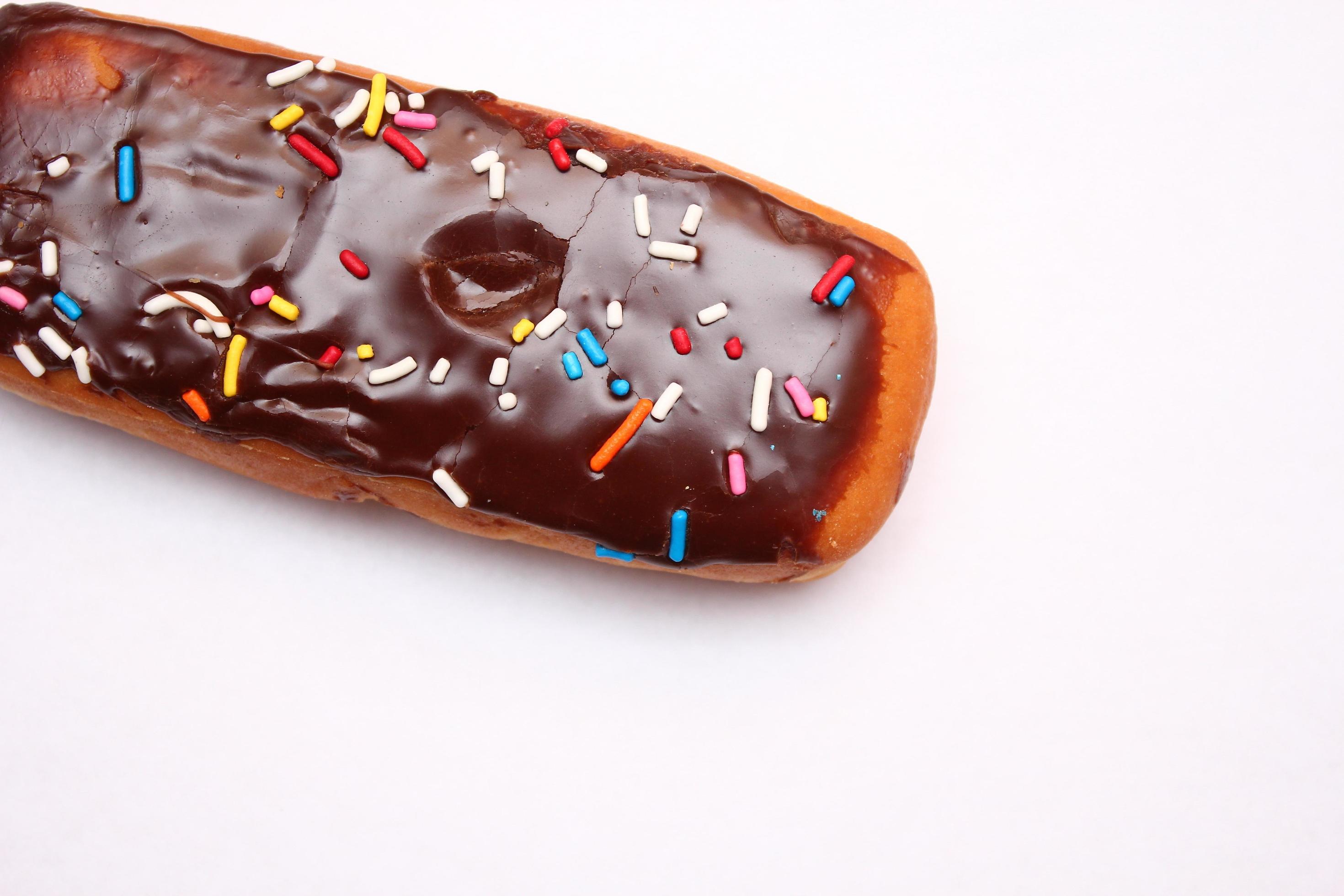 Chocolate donut bar topped with multicolored sugar flakes. laid on a white background 13310457