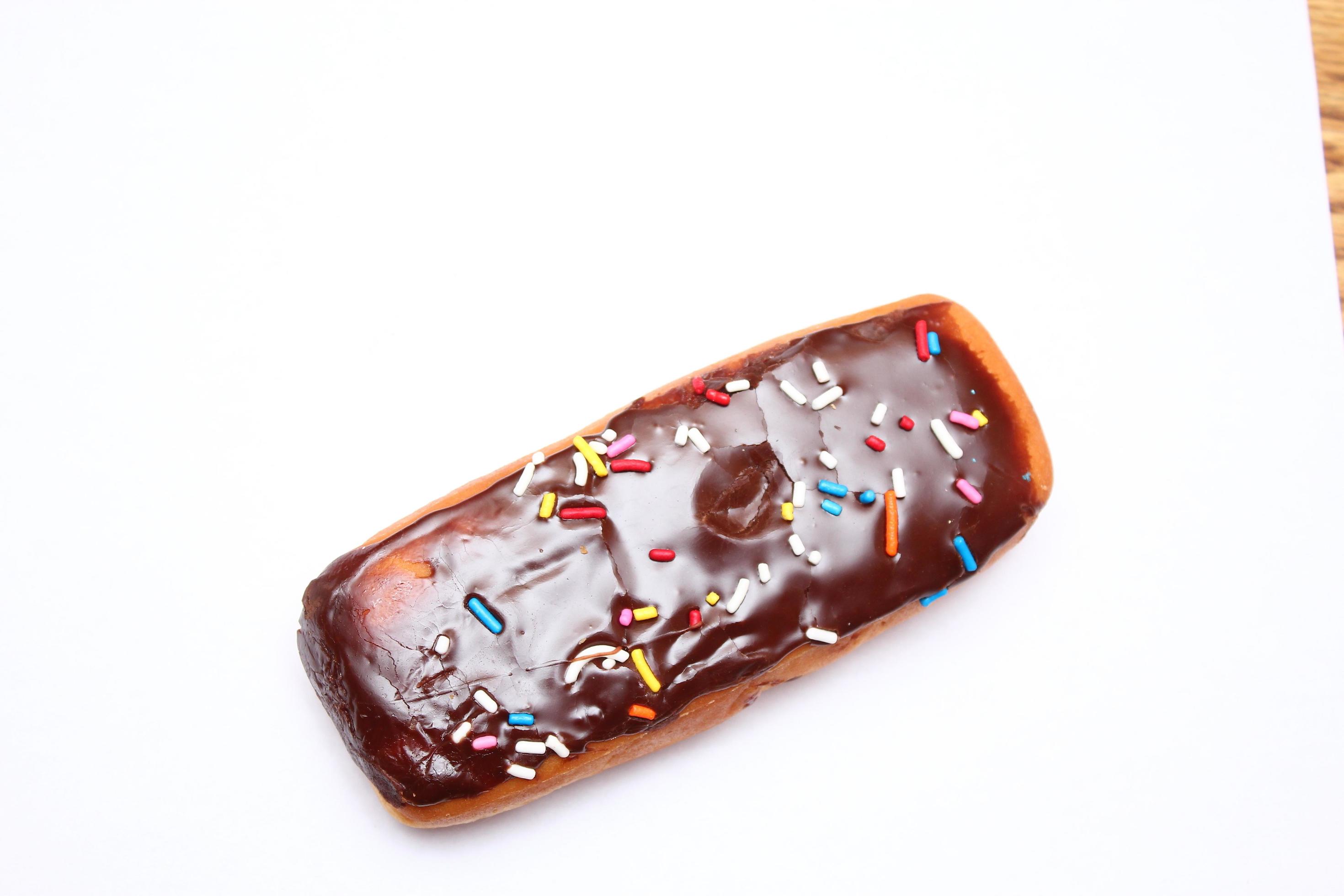 Chocolate donut bar topped with multicolored sugar flakes. laid on a white background 13310460