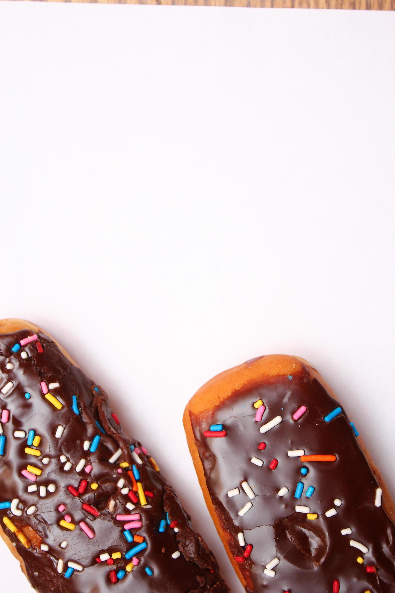 Chocolate donut bar topped with multicolored sugar flakes. laid on a white background 13310511