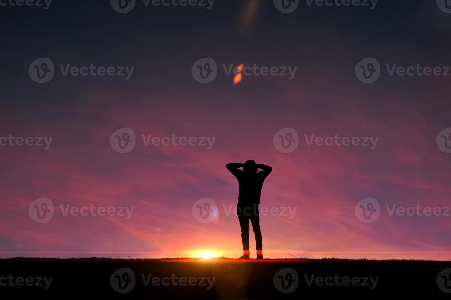 man trekking in the mountain with a sunset background in summertime photo