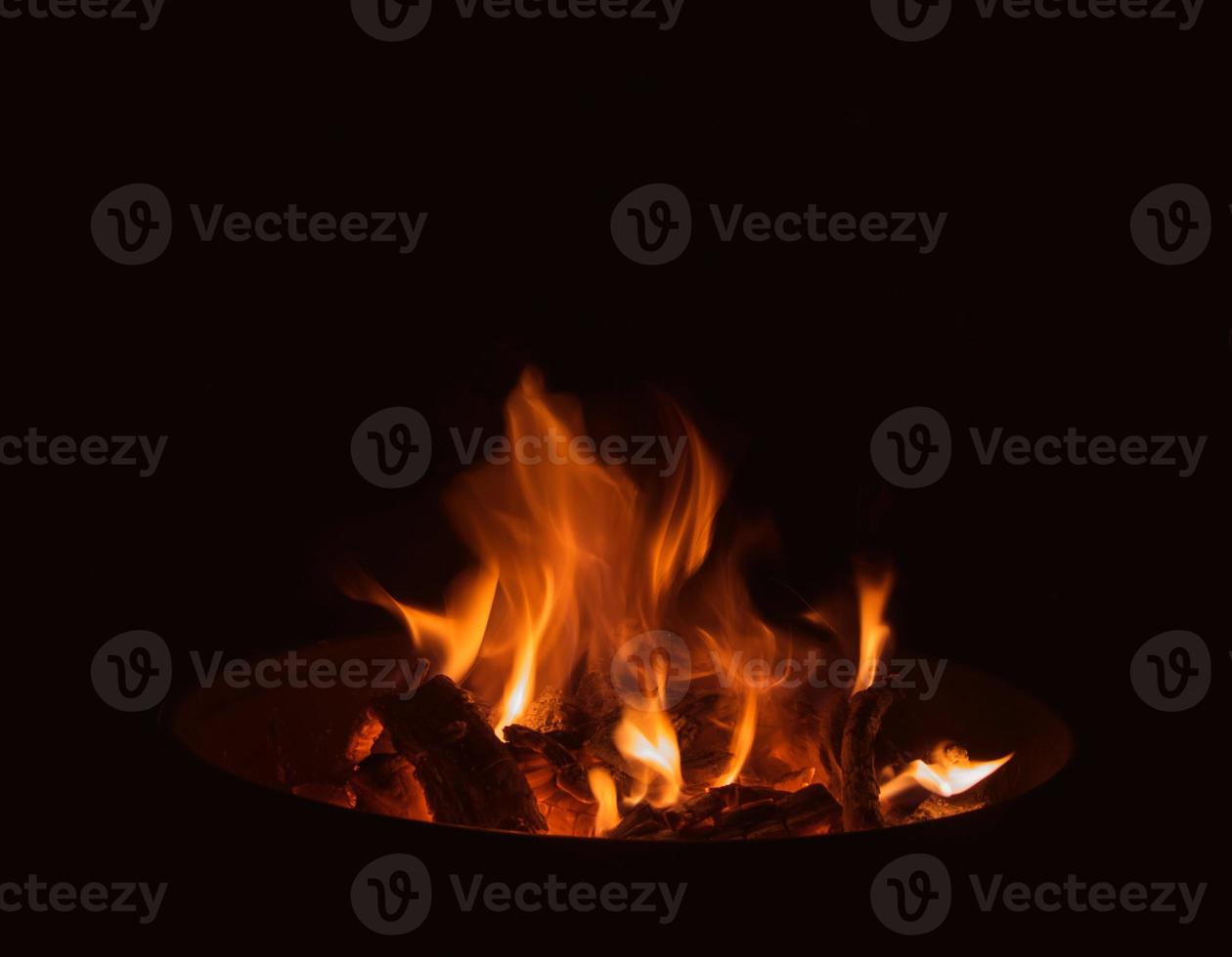 A flame burning in a brazier in the dark photo