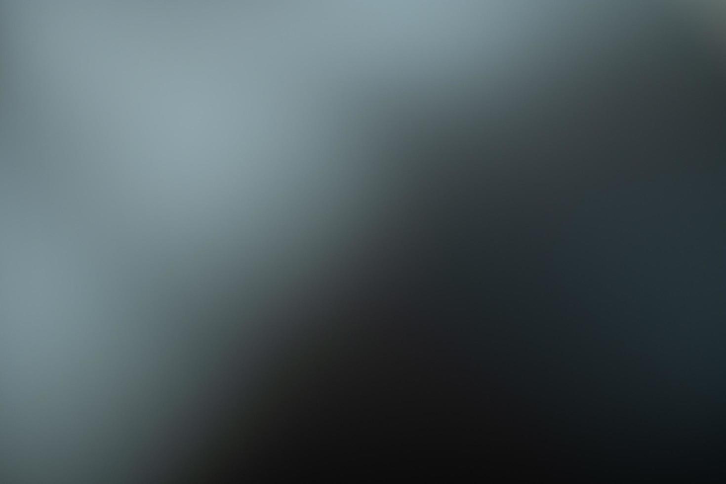 Dark black and gray blurred  gradient background has a little abstract light. photo