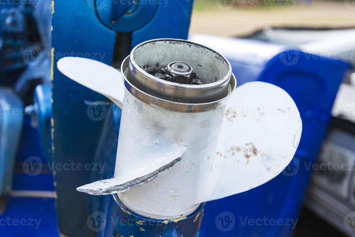 Damaged outboard motor propeller, aluminum propeller with a broken blade close-up, a problem on fishing photo