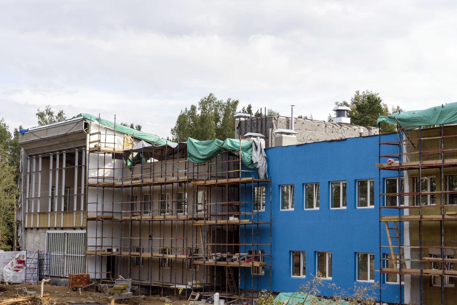 The progress of the construction of the kindergarten building. Colorful cheerful modern decoration of building facades photo