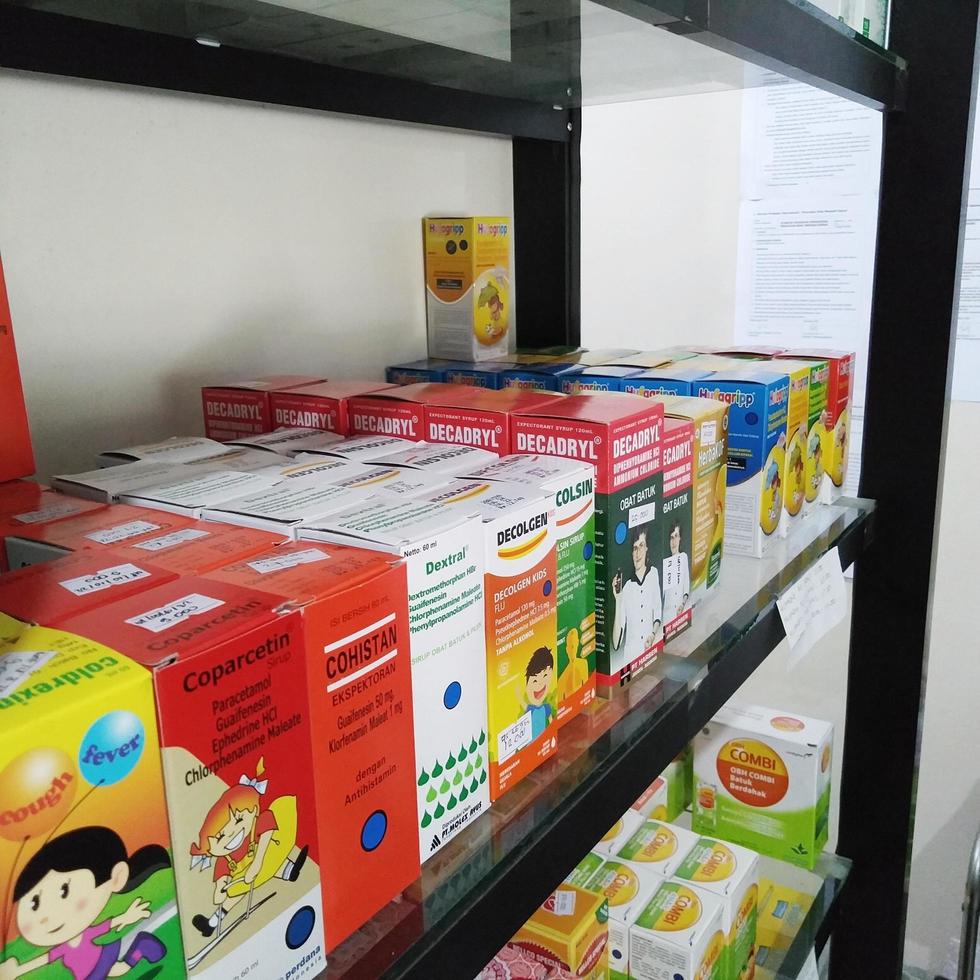 Depok, Indonesia, October 21, 2022, various brands of liquid medicine or syrup to reduce fever, relieve dry cough and phlegm for children or adults found in drug stores or pharmacies photo