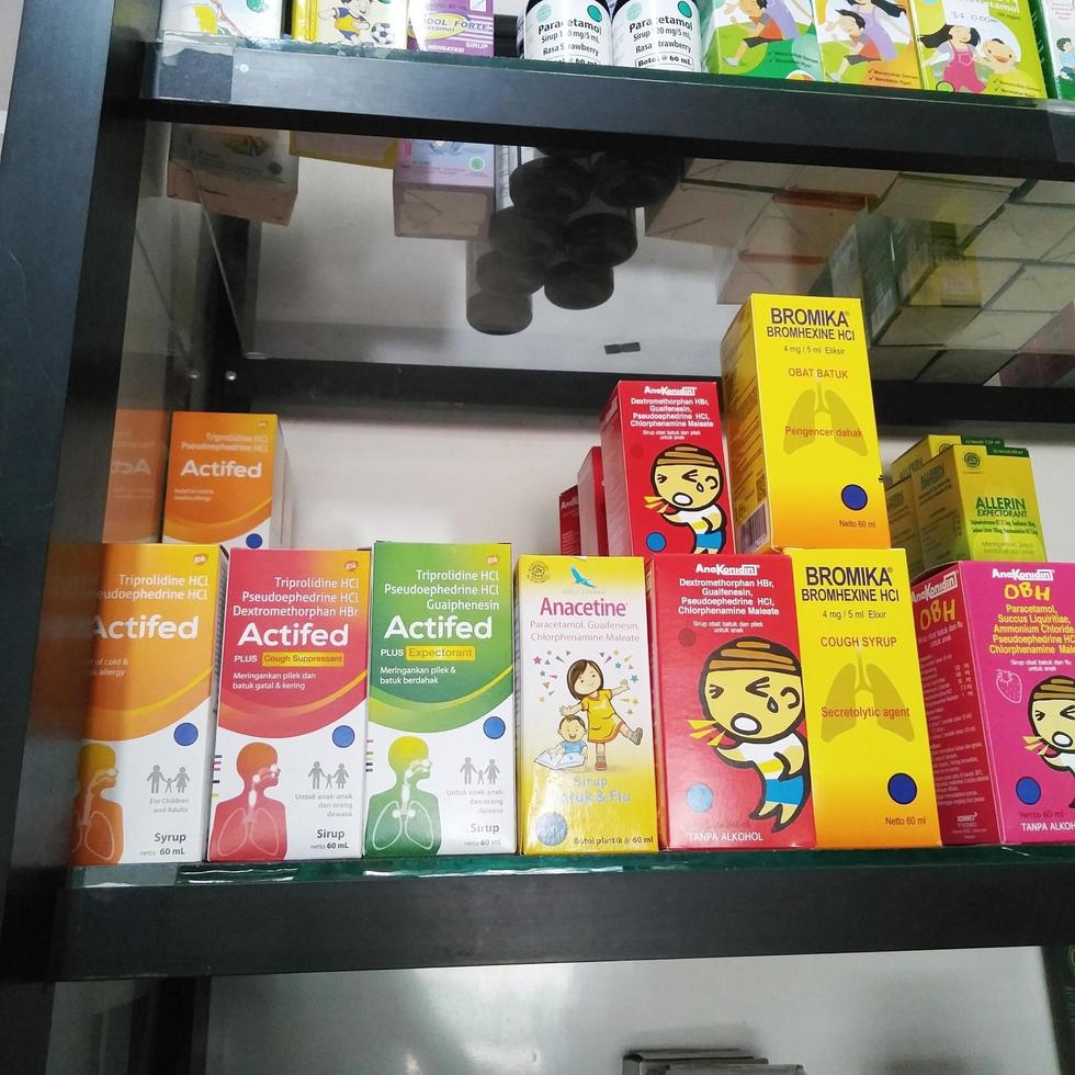 Depok, Indonesia, October 21, 2022, various brands of liquid medicine or syrup to reduce fever, relieve dry cough and phlegm for children or adults found in drug stores or pharmacies photo