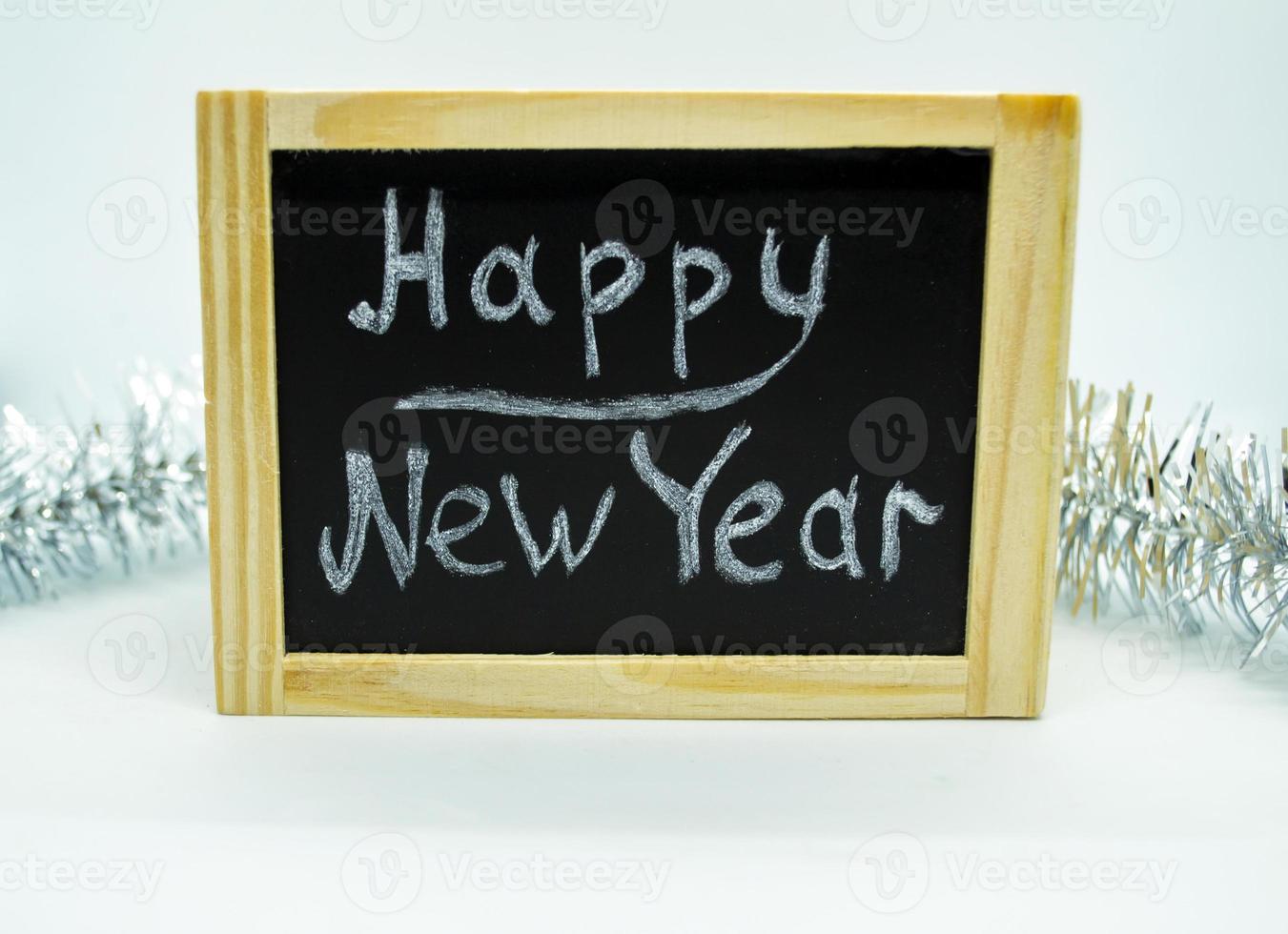 Inscription Happy New Year and tinsel. photo