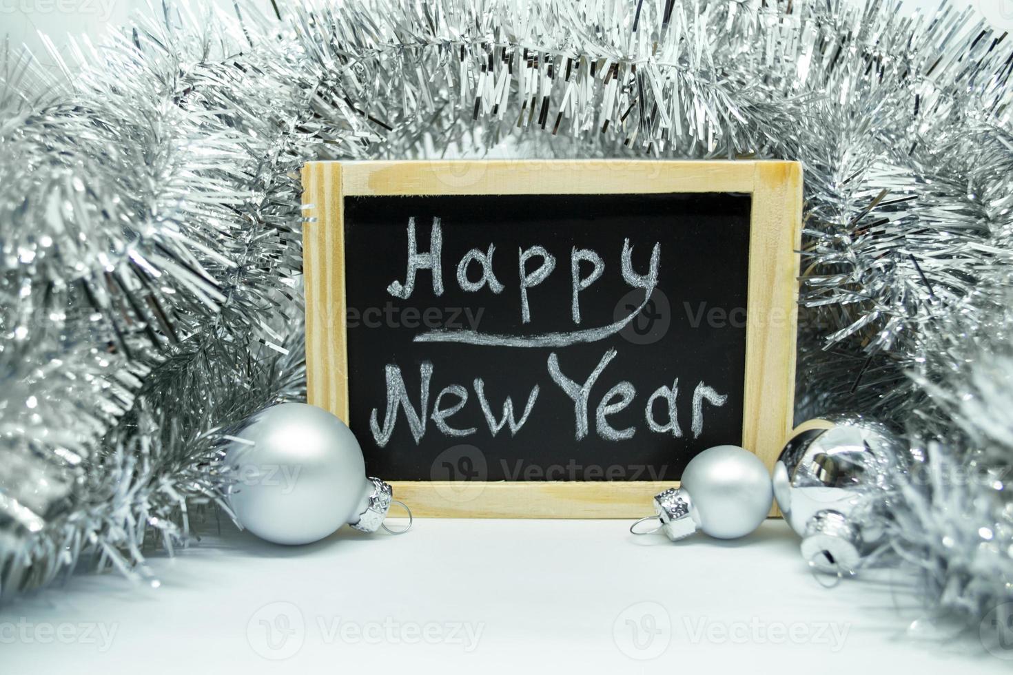 Lettering Happy New Year, Christmas balls and tinsel. photo
