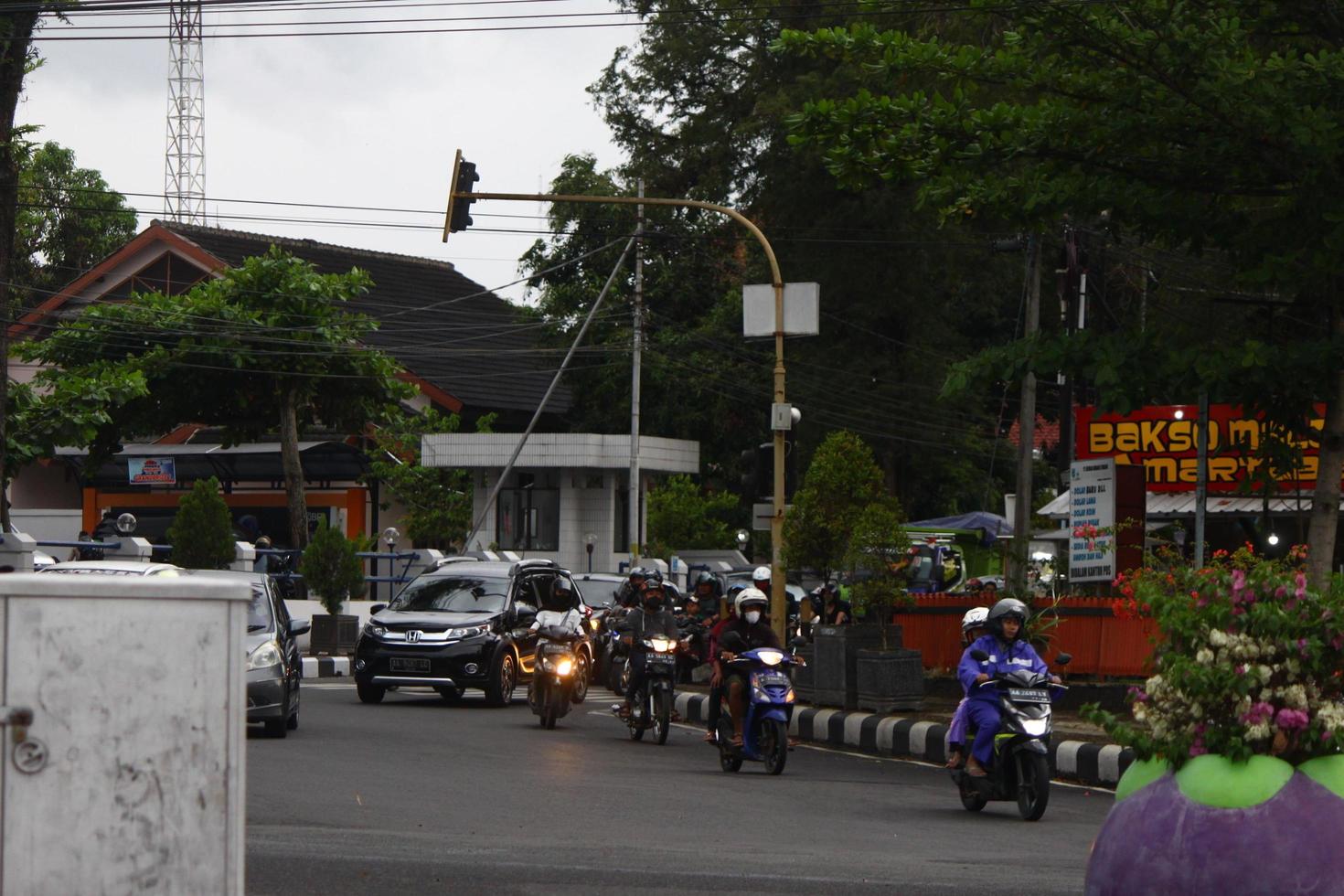 Magelang, Indonesia, 2022 - photo of many motorized vehicles driving on the streets in the afternoon