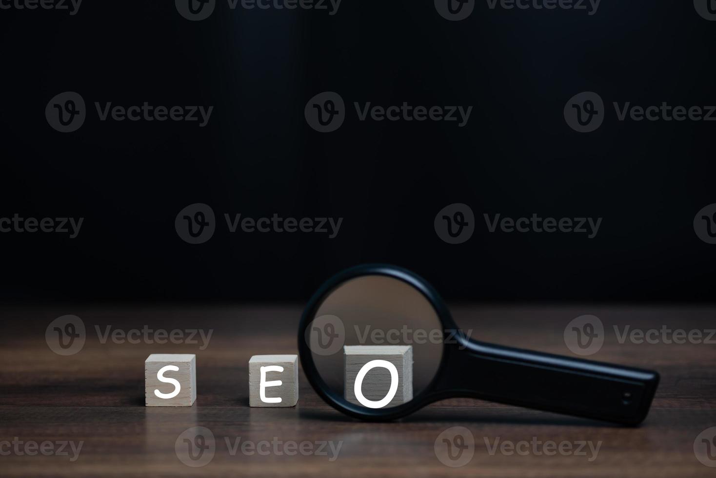 Magnifying glass with SEO wooden block, Search Engine Optimization,SEO, Technology for Mobile Phone, Smartphone, Computer, Web Page, Website, Social Media Ranking and Speed. photo