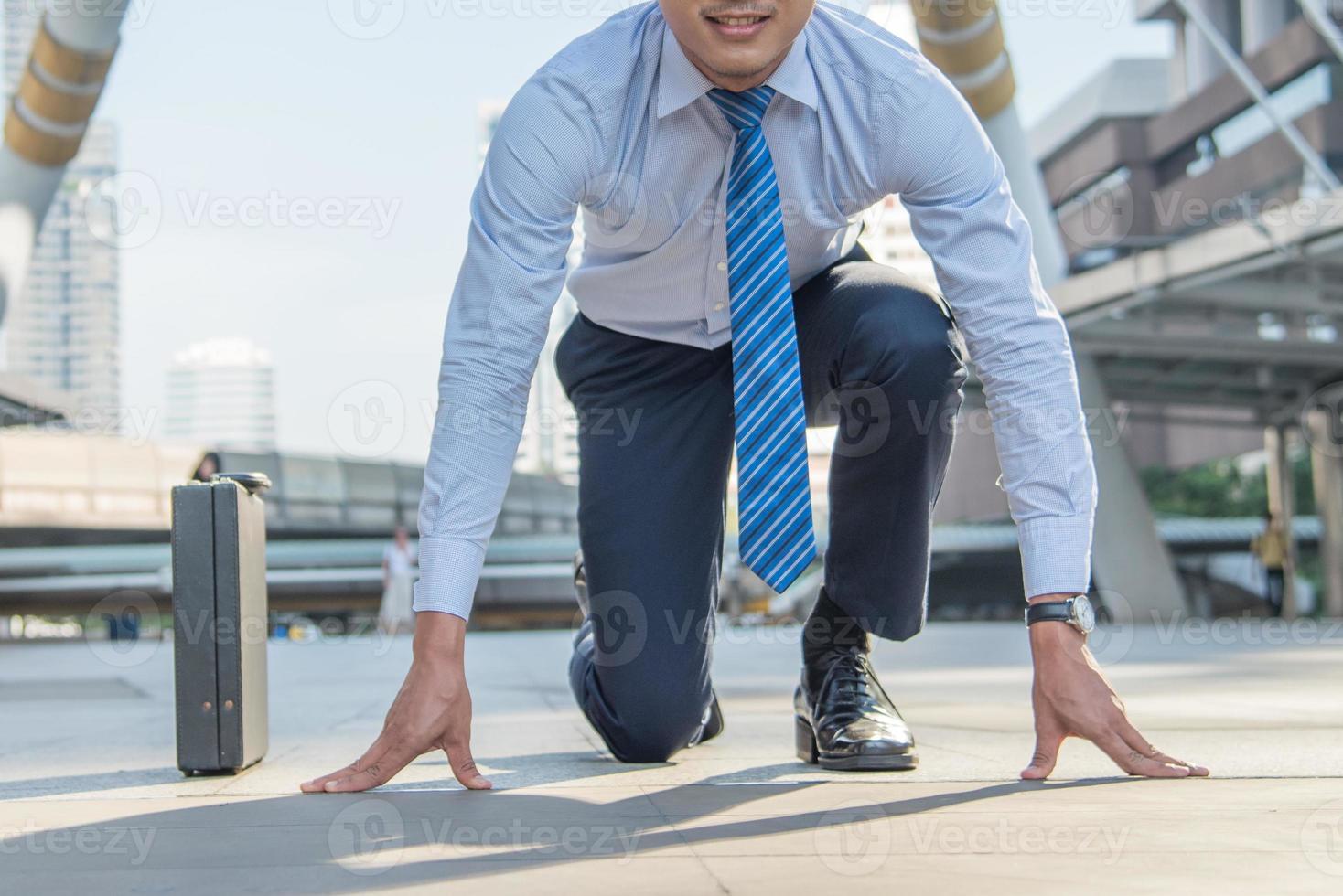 2023 start, Business man getting ready for race running in business on the city background, business competition successful concepts. photo