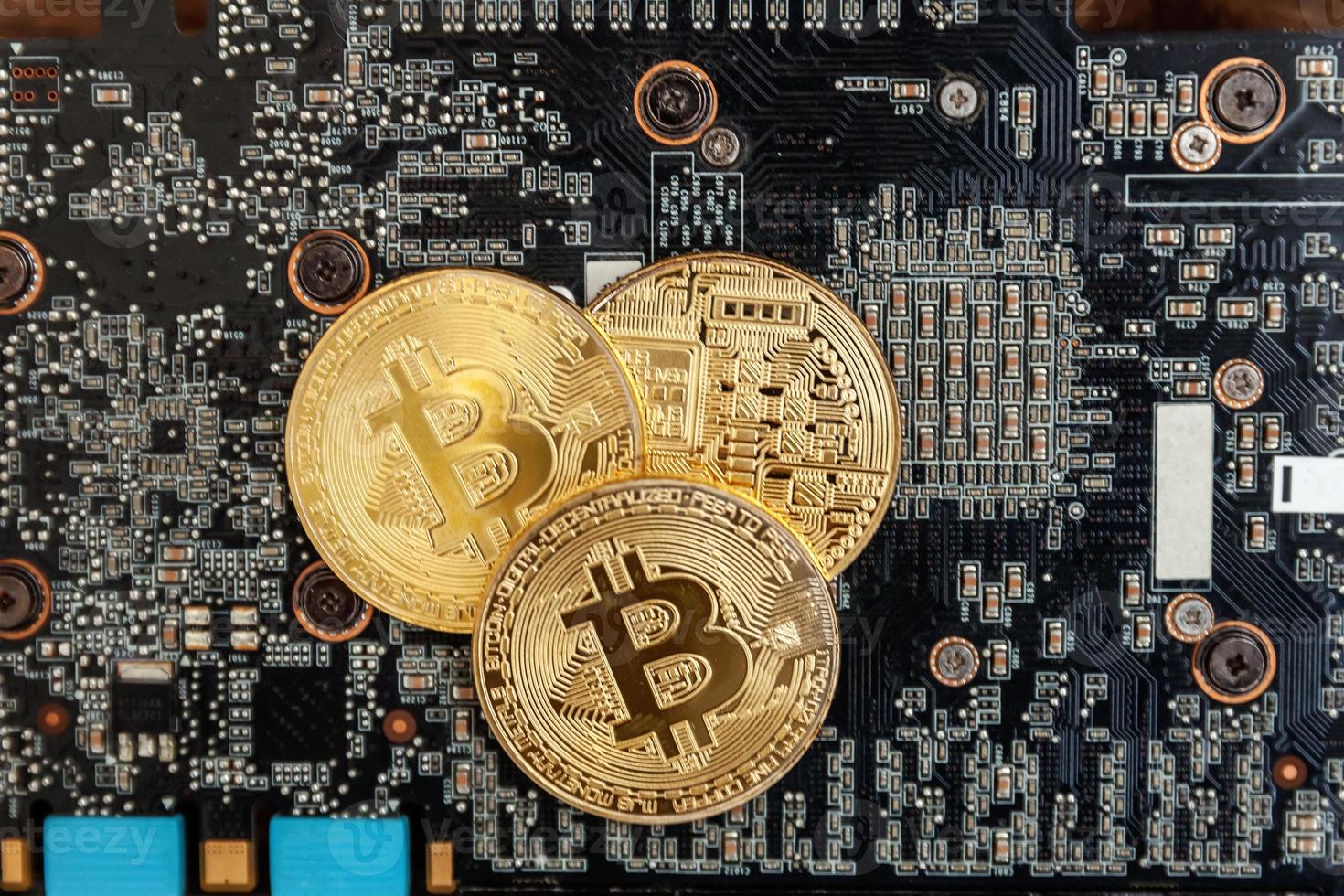 Cryptocurrency golden bitcoin coin lying on video card. Electronic virtual money for web banking and international network payment. Symbol of crypto virtual currency. Mining concept. photo