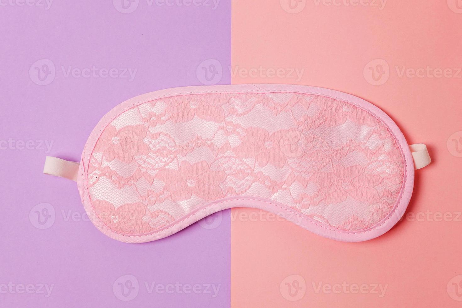 Sleeping eye mask, isolated on violet and pink pastel colorful trendy geometric background. Do not disturb me, let me sleep. Rest, good night, insomnia, relaxation, tired, travel concept. photo