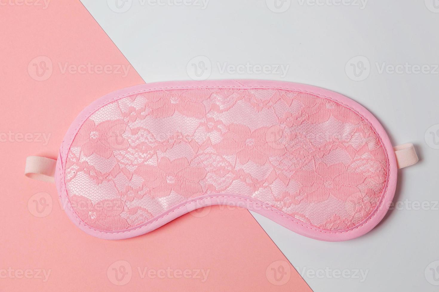 Sleeping eye mask, isolated on white and pink pastel colorful trendy geometric background. Do not disturb me, let me sleep. Rest, good night, insomnia, relaxation, tired, travel concept. photo