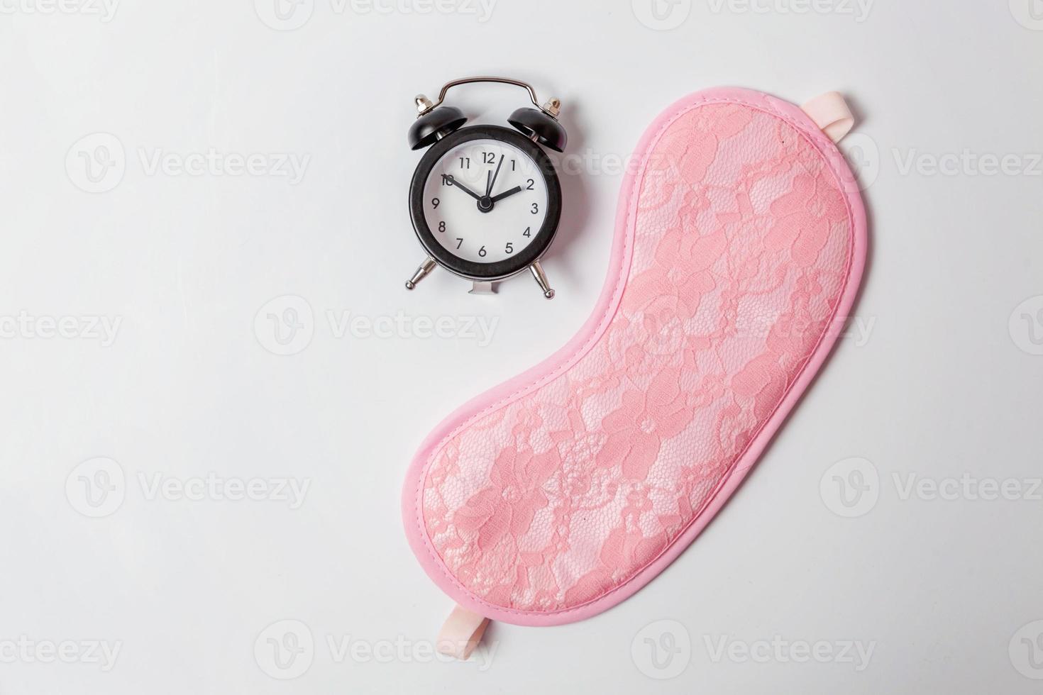 Sleeping eye mask, alarm clock isolated on white background. Do not disturb me, let me sleep. Rest, good night, siesta, insomnia, relaxation, tired, travel concept. photo