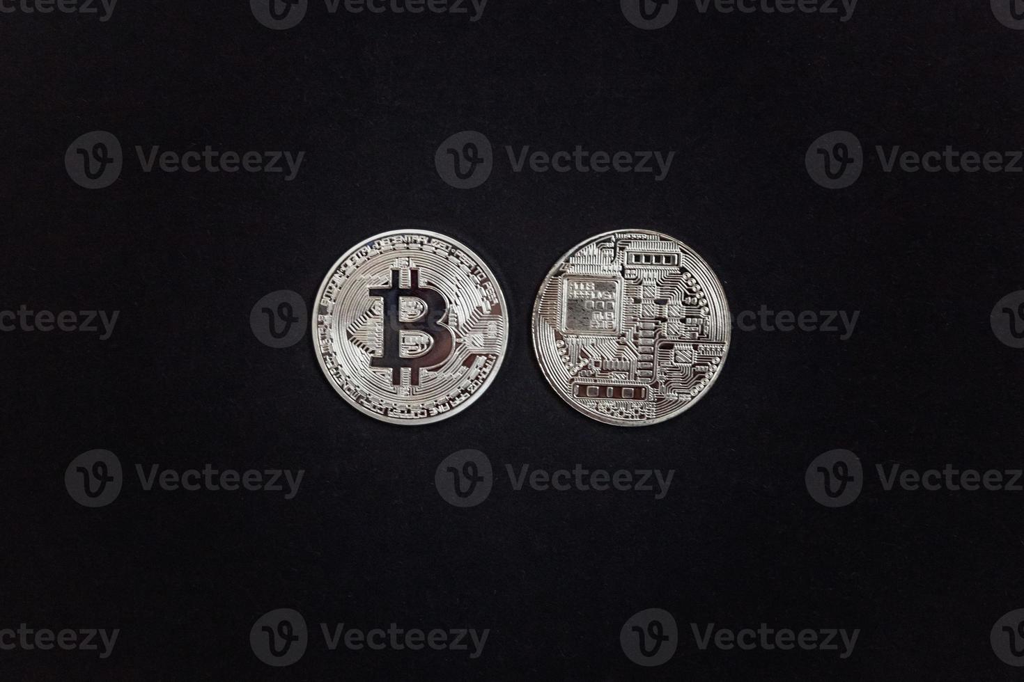 Cryptocurrency silver bitcoin coin on black background. Electronic virtual money for web banking and international network payment. Symbol of crypto virtual currency. Mining concept. photo
