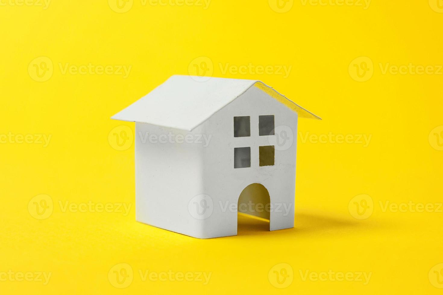 Simply design with miniature white toy house isolated on yellow colourful trendy modern fashion background. Mortgage property insurance dream home concept. Copy space. photo