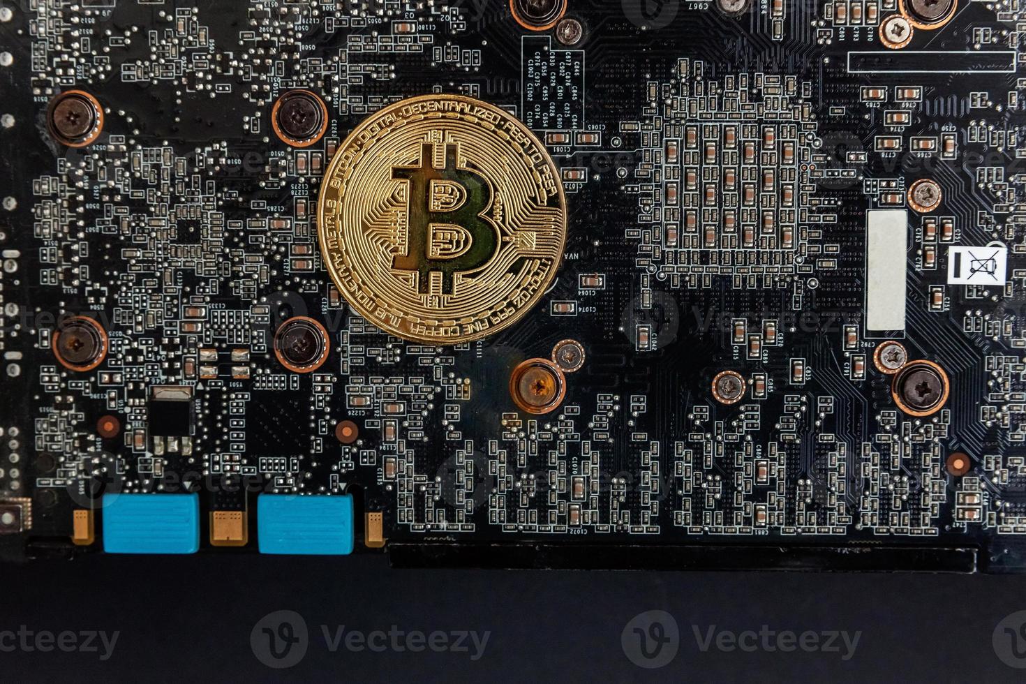 Cryptocurrency golden bitcoin coin lying on video card. Electronic virtual money for web banking and international network payment. Symbol of crypto virtual currency. Mining concept. photo