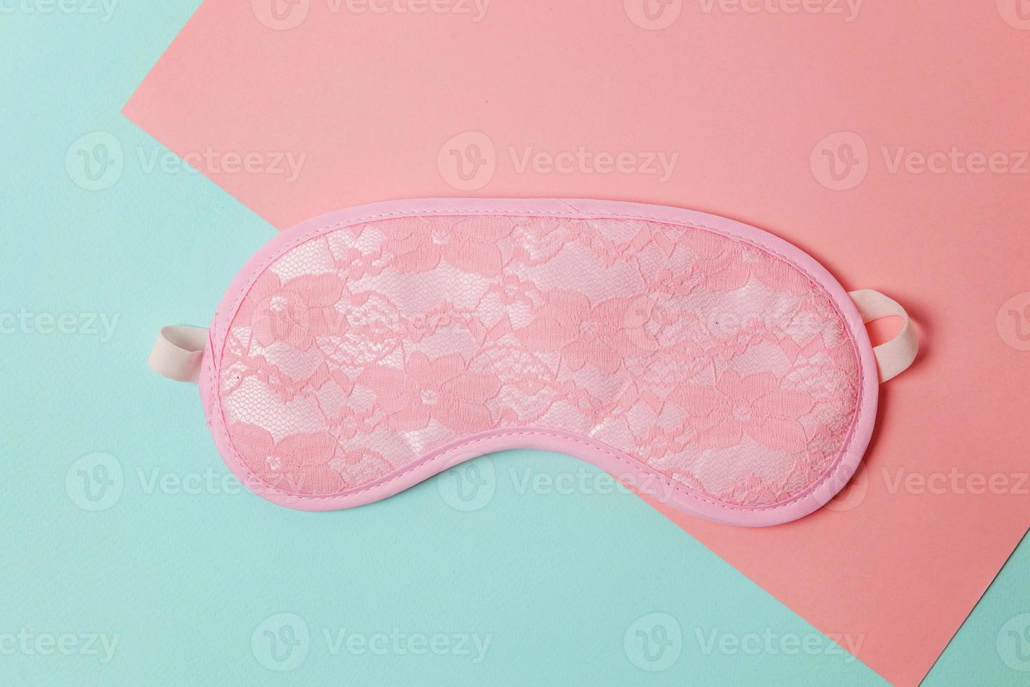 Sleeping eye mask alarm clock isolated on blue pink pastel colorful trendy geometric background. Do not disturb me, let me sleep. Rest, good night, siesta, insomnia, relaxation, tired, travel concept. photo