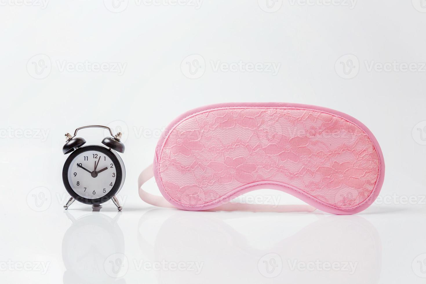 Sleeping eye mask, alarm clock isolated on white background. Do not disturb me, let me sleep. Rest, good night, siesta, insomnia, relaxation, tired, travel concept. photo
