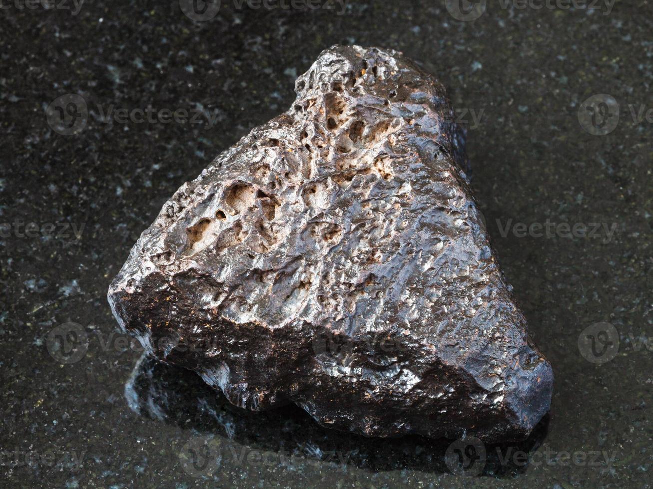 rough Hematite stone on black photo