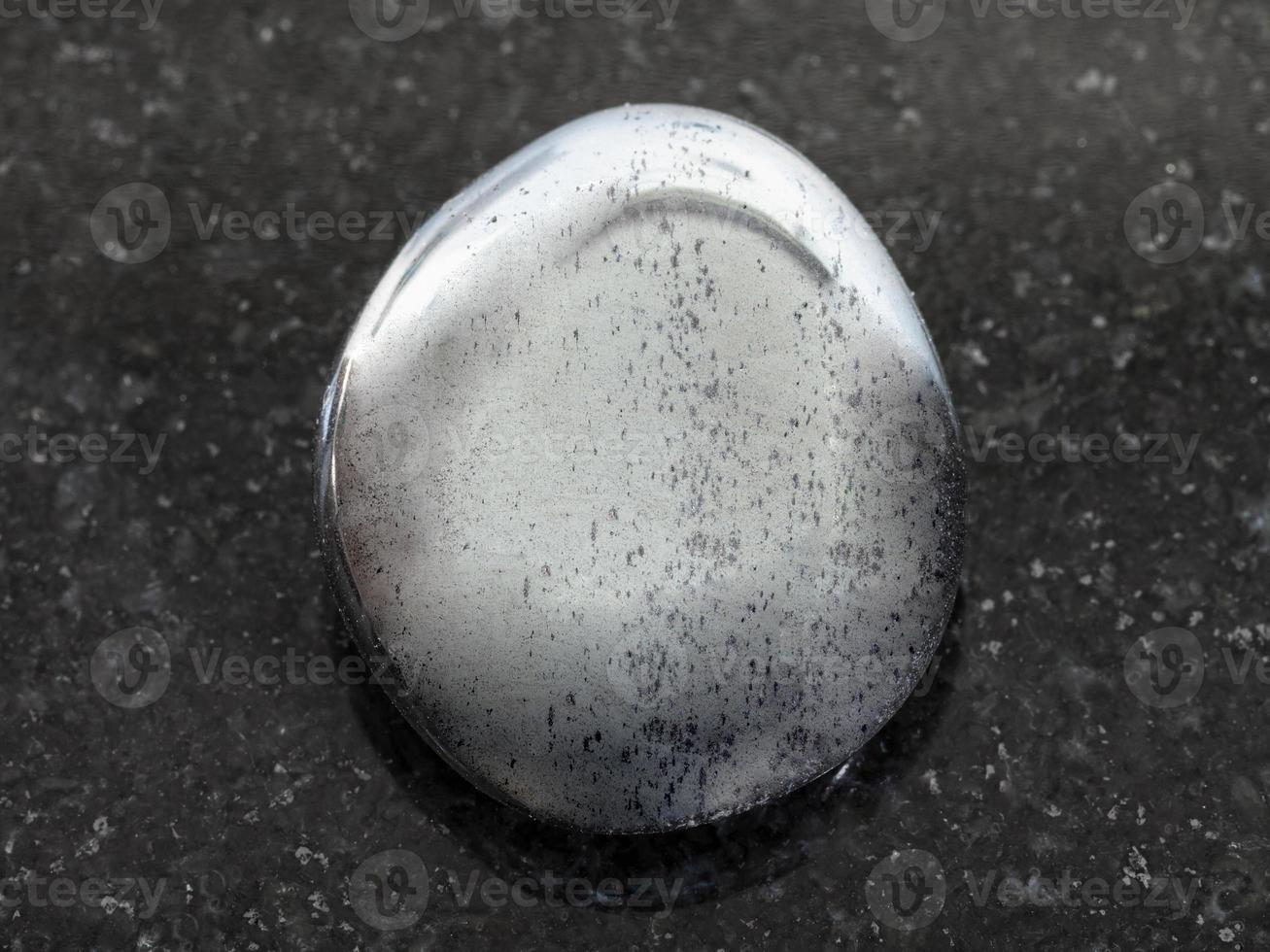 polished hematite gemstone on dark background photo