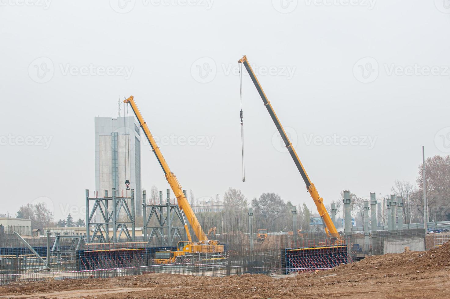 A track crane working in a industrial construction area photo