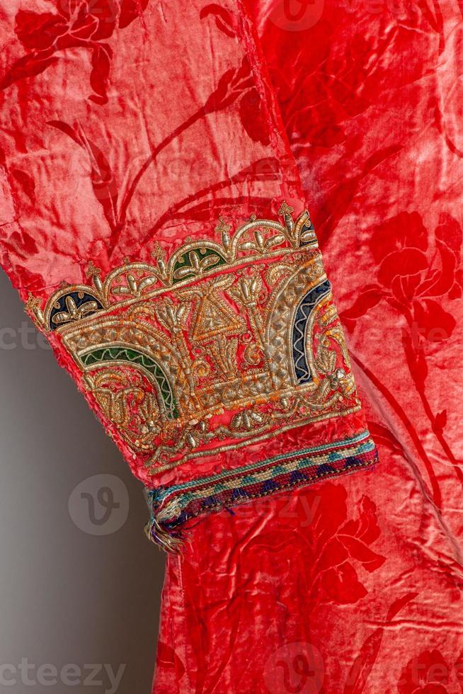 The decorative elements and ornaments on the Uzbekistan national robe sleeve photo