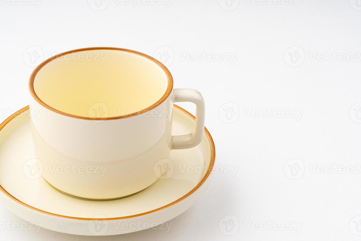 A set of white and brown ceramic plate and cup on a white background photo