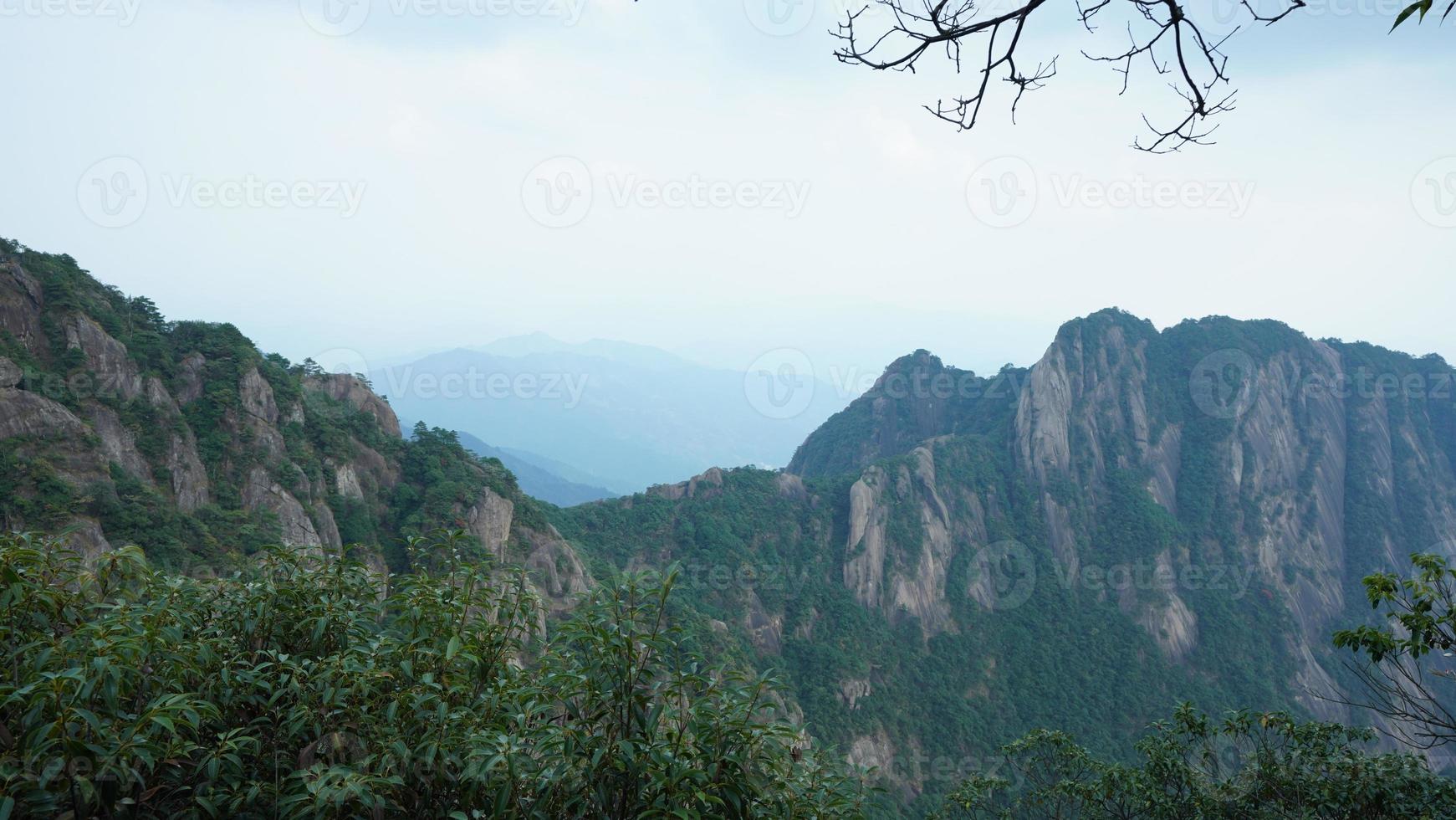 The beautiful mountains landscapes with the green forest and the erupted rock cliff as background in the countryside of the China photo