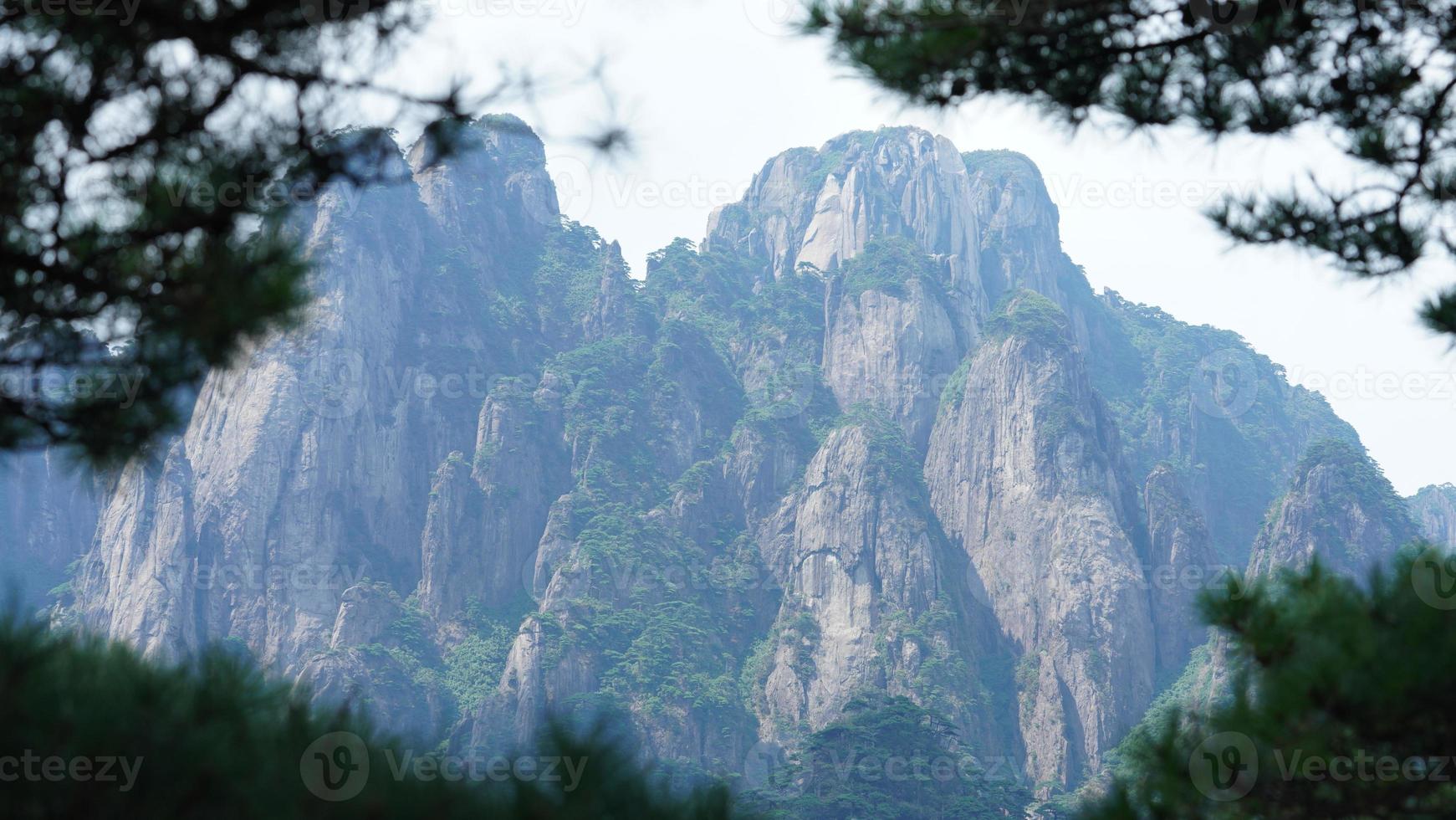 The beautiful mountains landscapes with the green forest and the erupted rock cliff as background in the countryside of the China photo