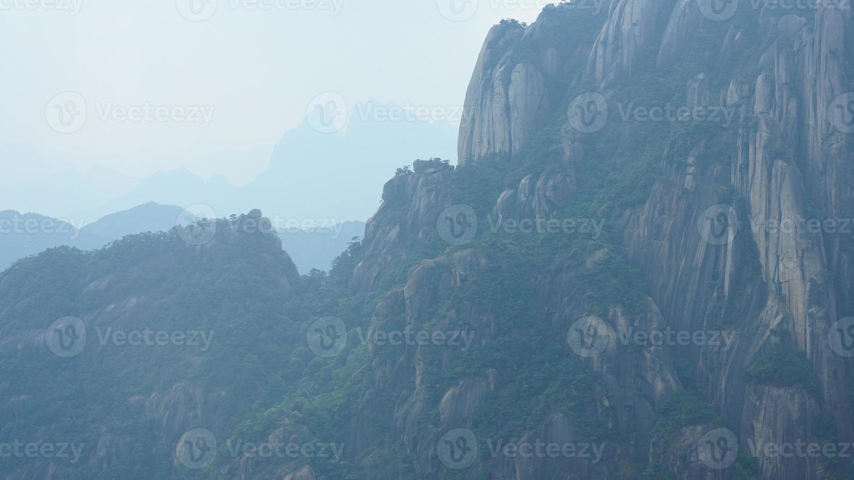 The beautiful mountains landscapes with the green forest and erupted rock cliff as background in the countryside of the China photo