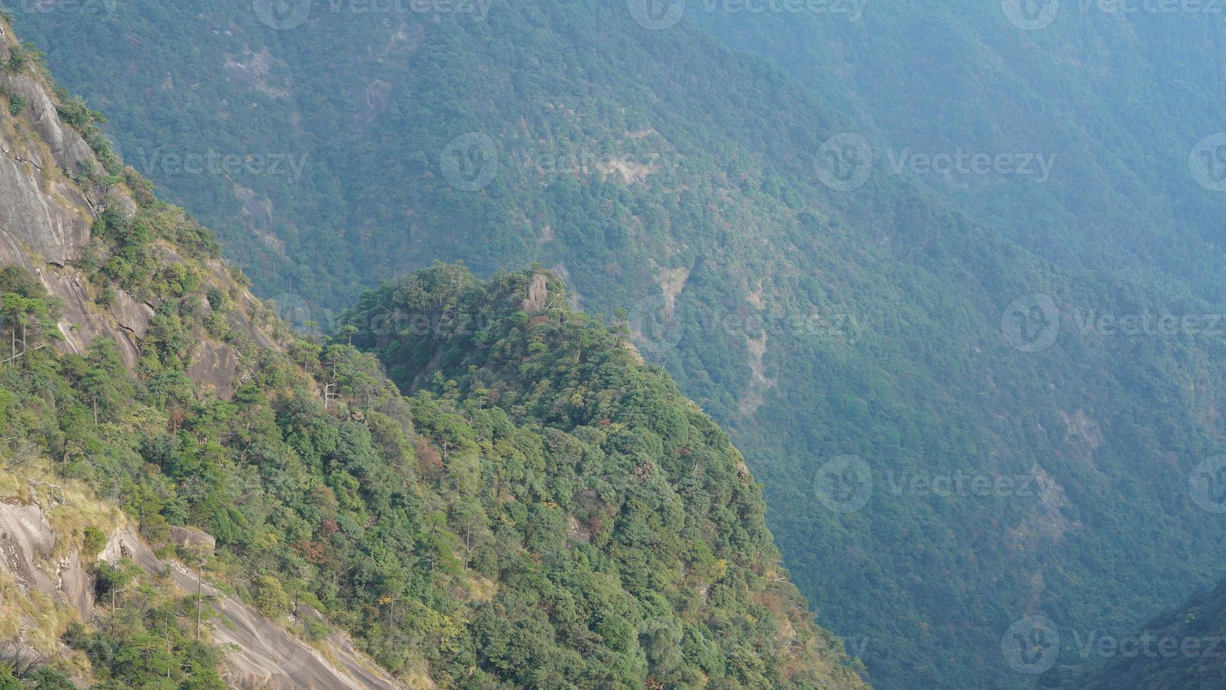 The beautiful mountains landscapes with the green forest and the erupted rock cliff as background in the countryside of the China photo
