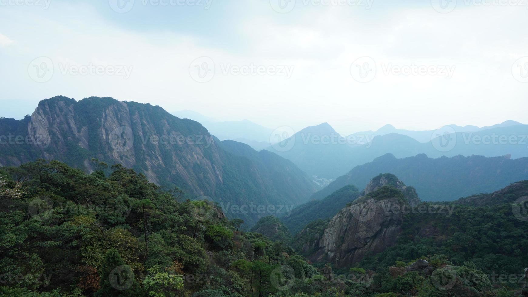 The beautiful mountains landscapes with the green forest and the erupted rock cliff as background in the countryside of the China photo